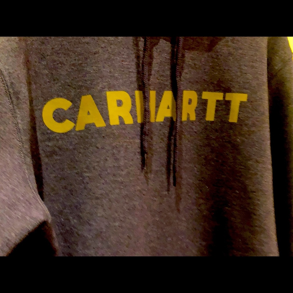 This sweatshirt is purple with gold lettering. Loose fit size large.